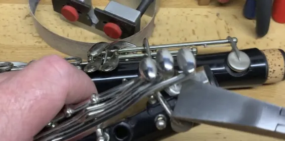 Clarinet Troubleshooting Tips, Adjusting the Bridge Mechanism**: For lower register note issues, follow these steps: - Remove the key covering the bridge (if necessary) - Use smooth pliers to gently adjust the bridge key